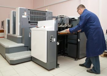 Printer working at his new offset machine